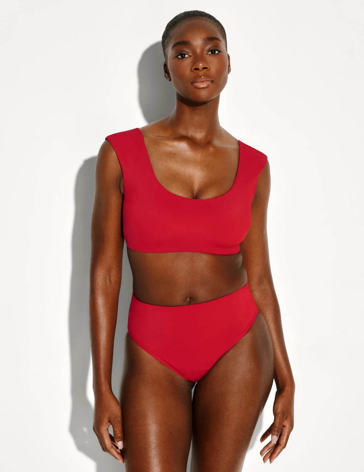 Front view of model wearing the Leakproof Sculpt High Rise Bikini Swim Bottom highlighting the coverage and fit – Cherry – view 2 of 21
