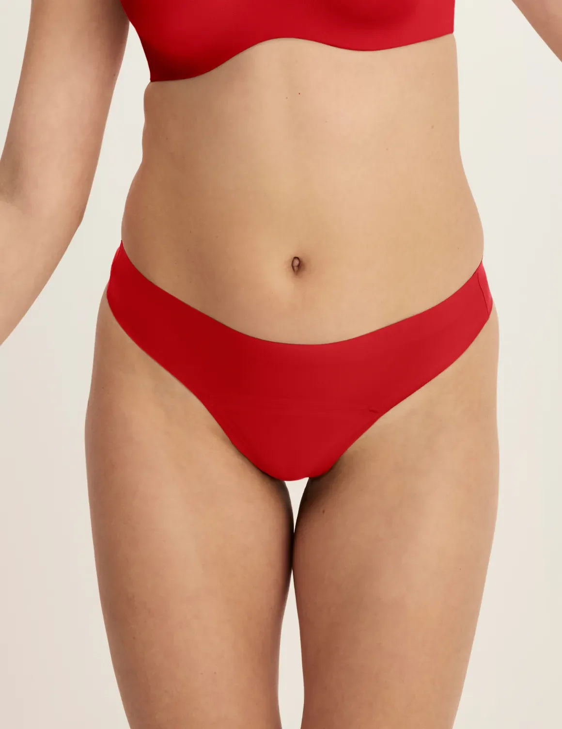 Front view of model wearing the Light Leakproof UltraThin No-Show Thong highlighting the coverage and smooth fit – Shimmer Cherry – view 5 of 40