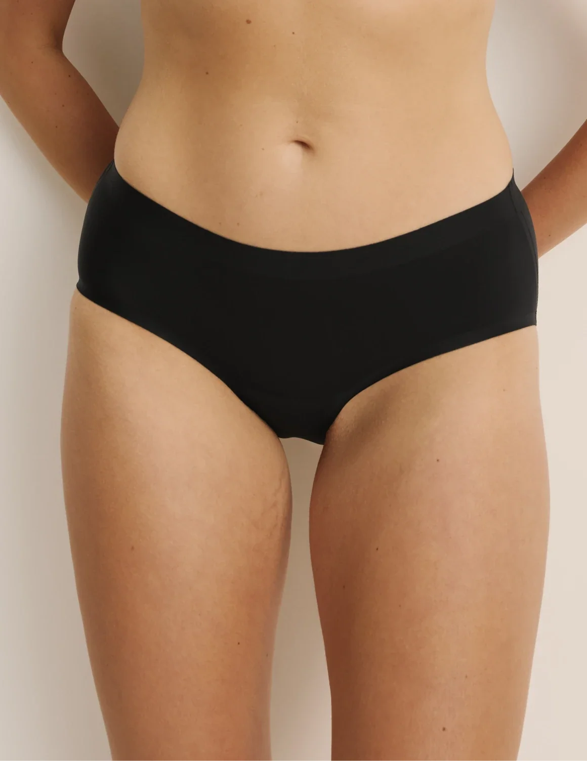 Front view of model wearing the Light Leakproof No-Show Boyshort highlighting the coverage and smooth fit – Black – view 1 of 17