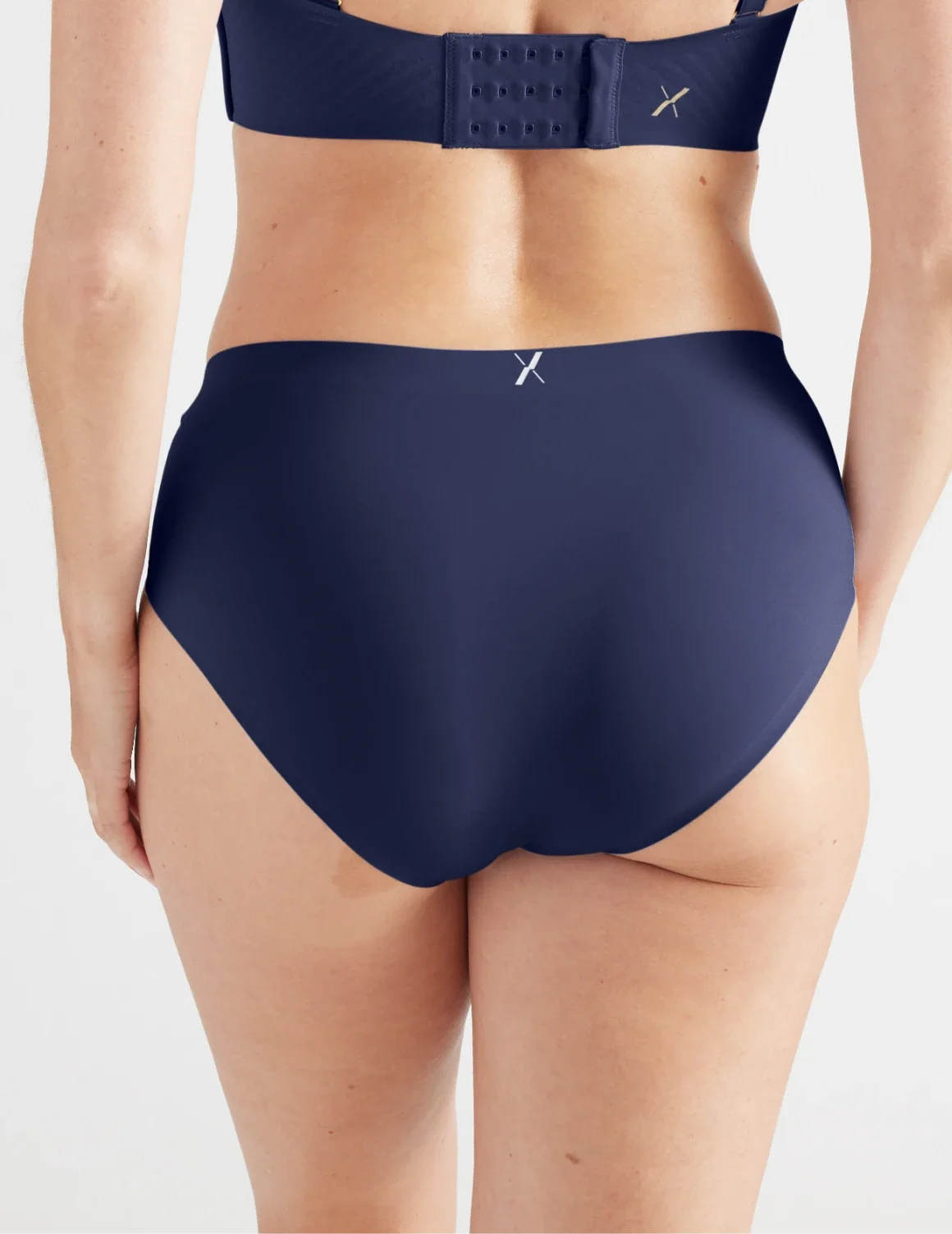 Back view of model wearing the Light Leakproof No-Show Boyshort highlighting the coverage and smooth fit – Midnight – view 6 of 17