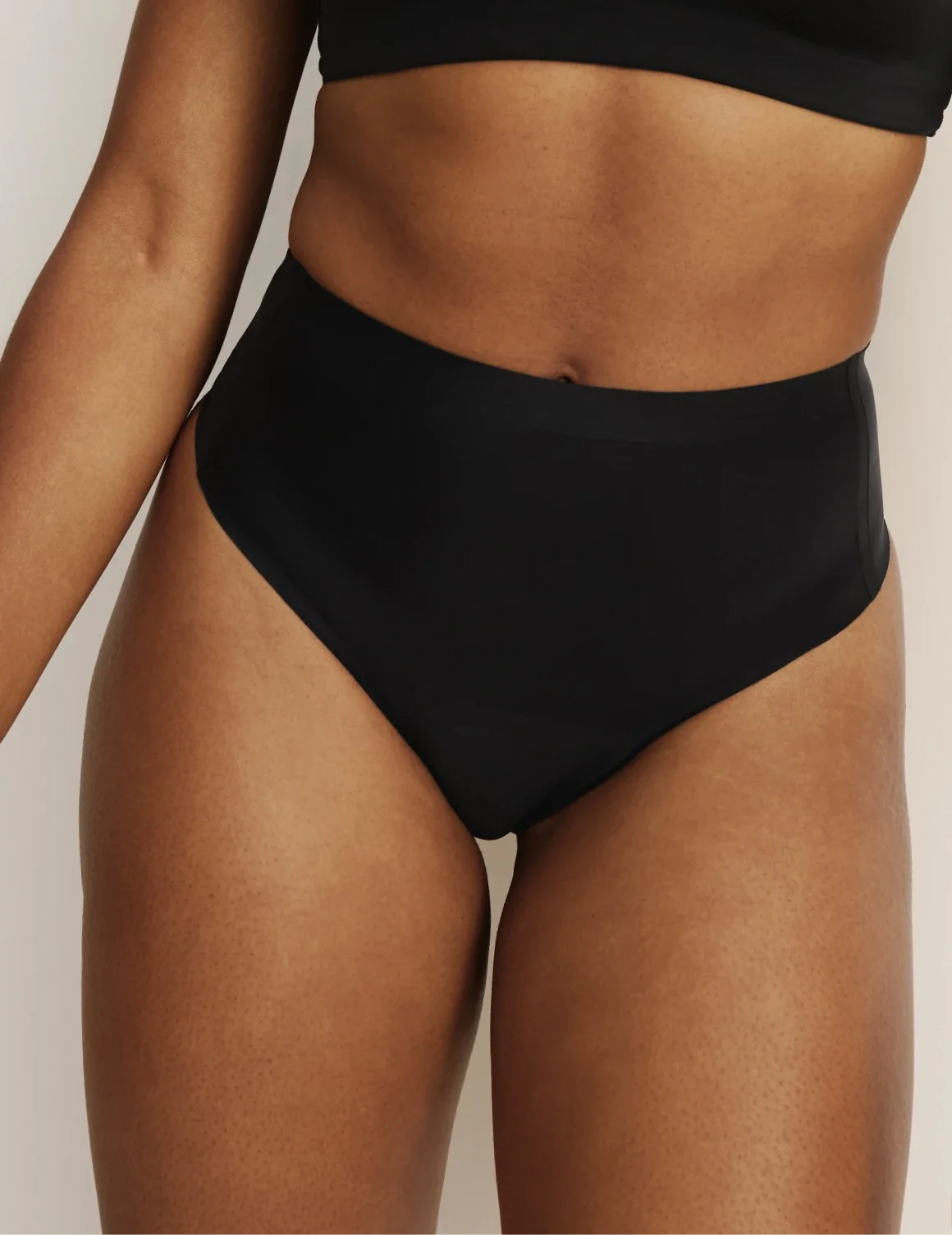 Front view of model wearing the Light Leakproof No-Show High Rise Thong highlighting the coverage and smooth fit – Black – view 1 of 9