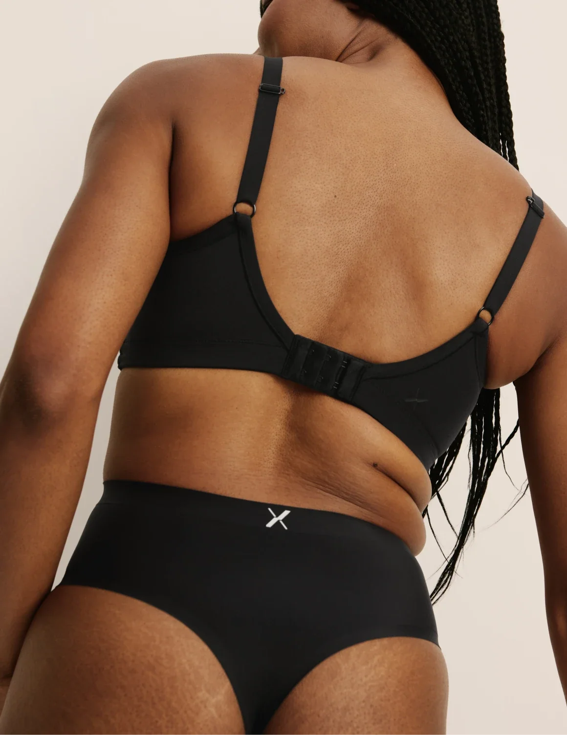 Back view of model wearing the Light Leakproof No-Show High Rise Thong highlighting the coverage and smooth fit – Black – view 3 of 9