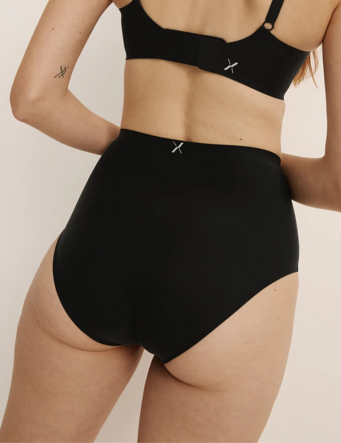 Back view of model wearing the Light Leakproof No-Show High Rise highlighting the coverage and smooth fit – Black – view 3 of 20