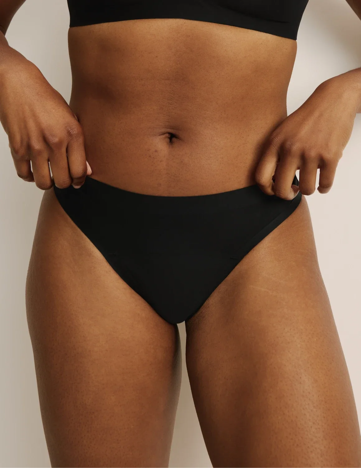 Front view of model wearing the Light Leakproof UltraThin No-Show Thong highlighting the coverage and smooth fit – Black – view 9 of 40