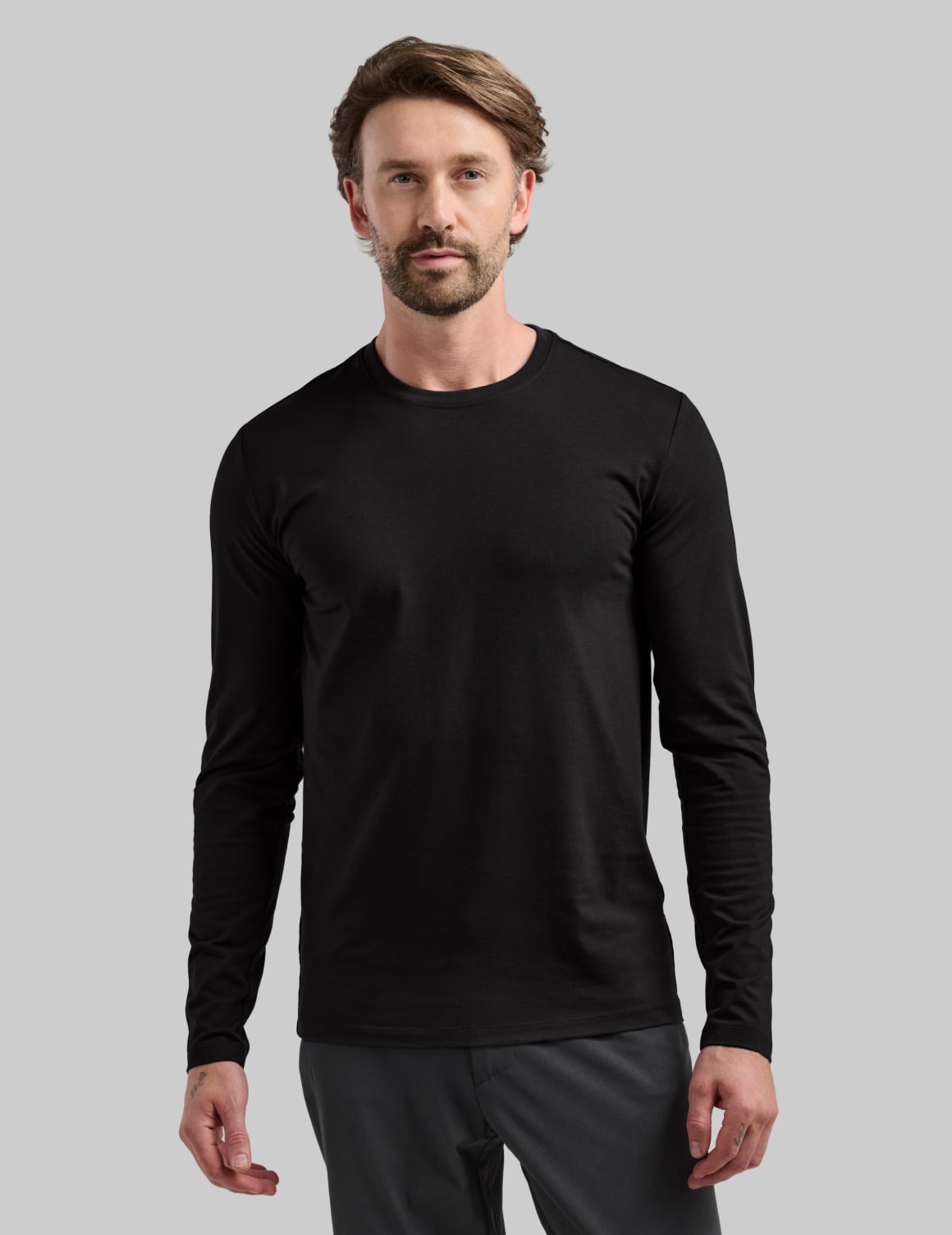 Front view of model wearing the Men's Best Damn Long Sleeve highlighting the coverage and fit – Black – view 1 of 13