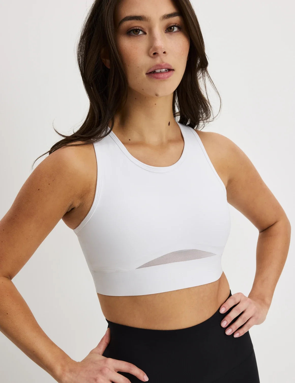 Front view of model wearing the Momenta Racerback Sports Bra, highlighting the neckline, strap design, and silhouette – Bright White – view 10 of 21
