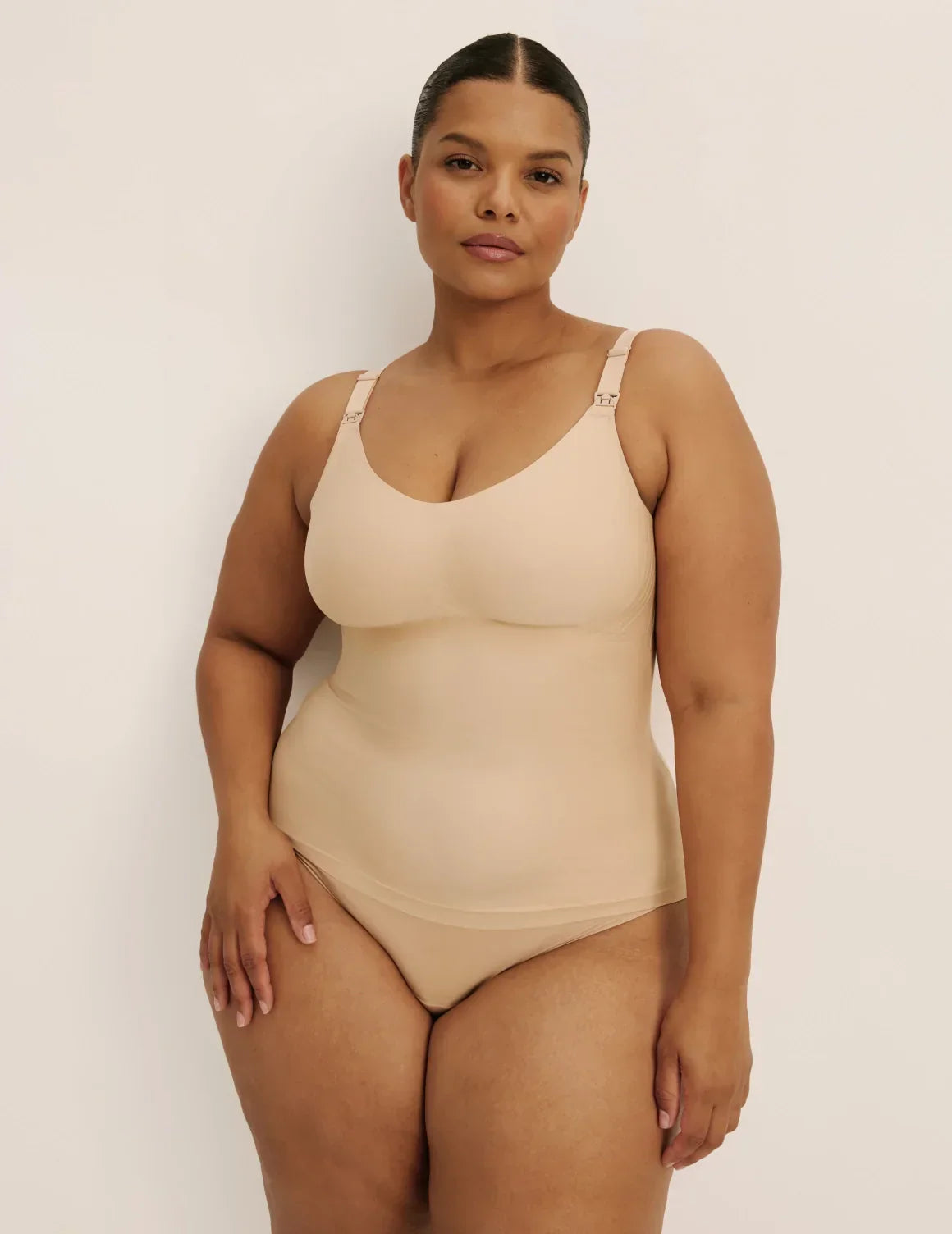 Front view of model wearing the Revolution Nursing Tank, highlighting the neckline, strap design, and smooth silhouette – Warm Sand – view 2 of 22