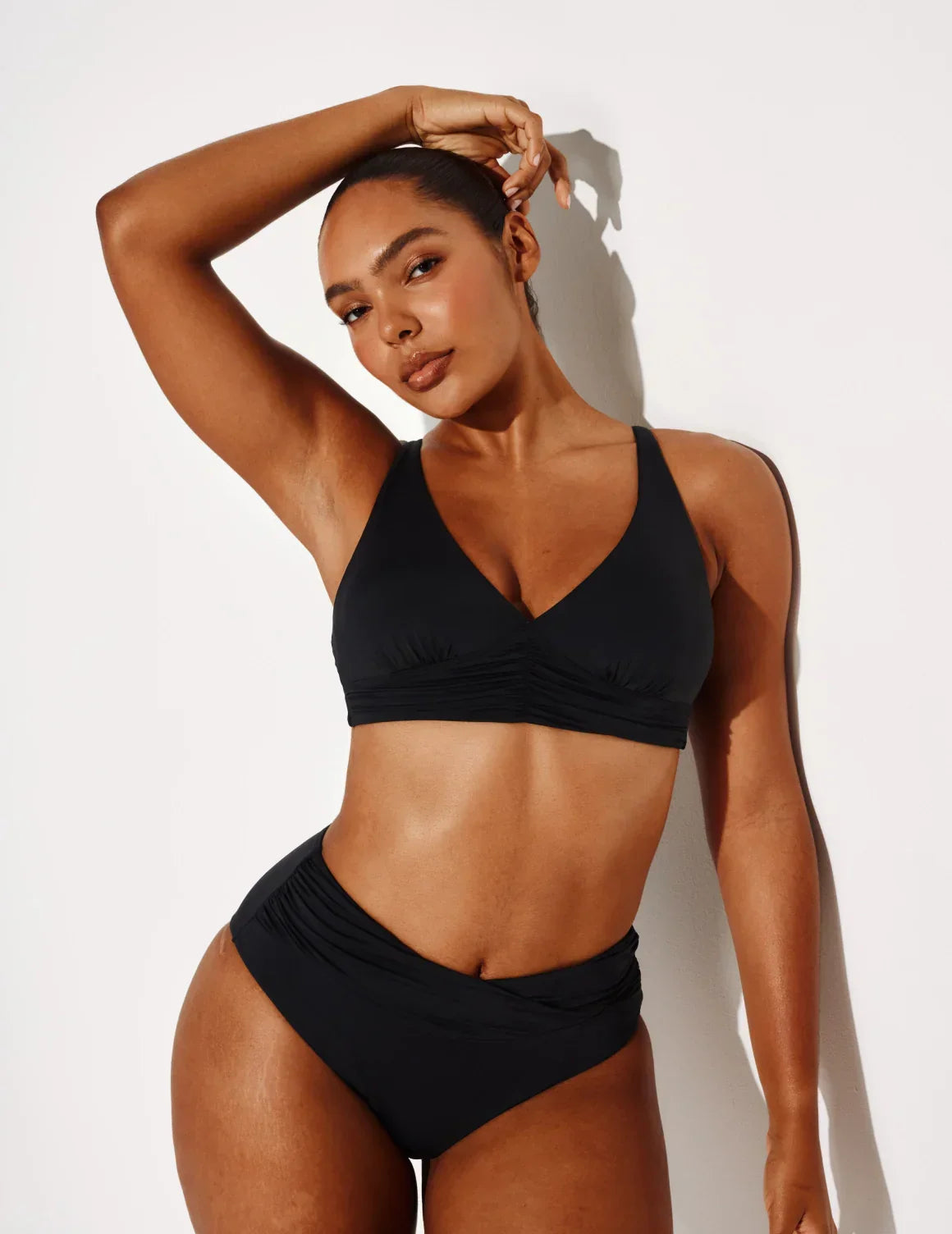 Front view of model wearing the Sculpt Ruched Bikini Swim Bottom highlighting the coverage and fit – Black – view 6 of 14