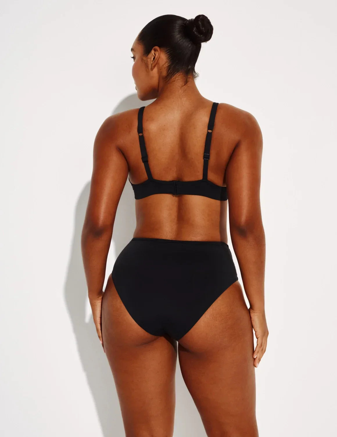 Back view of model wearing the Sculpt Ruched Bikini Swim Bottom highlighting the coverage and fit – Black – view 8 of 14
