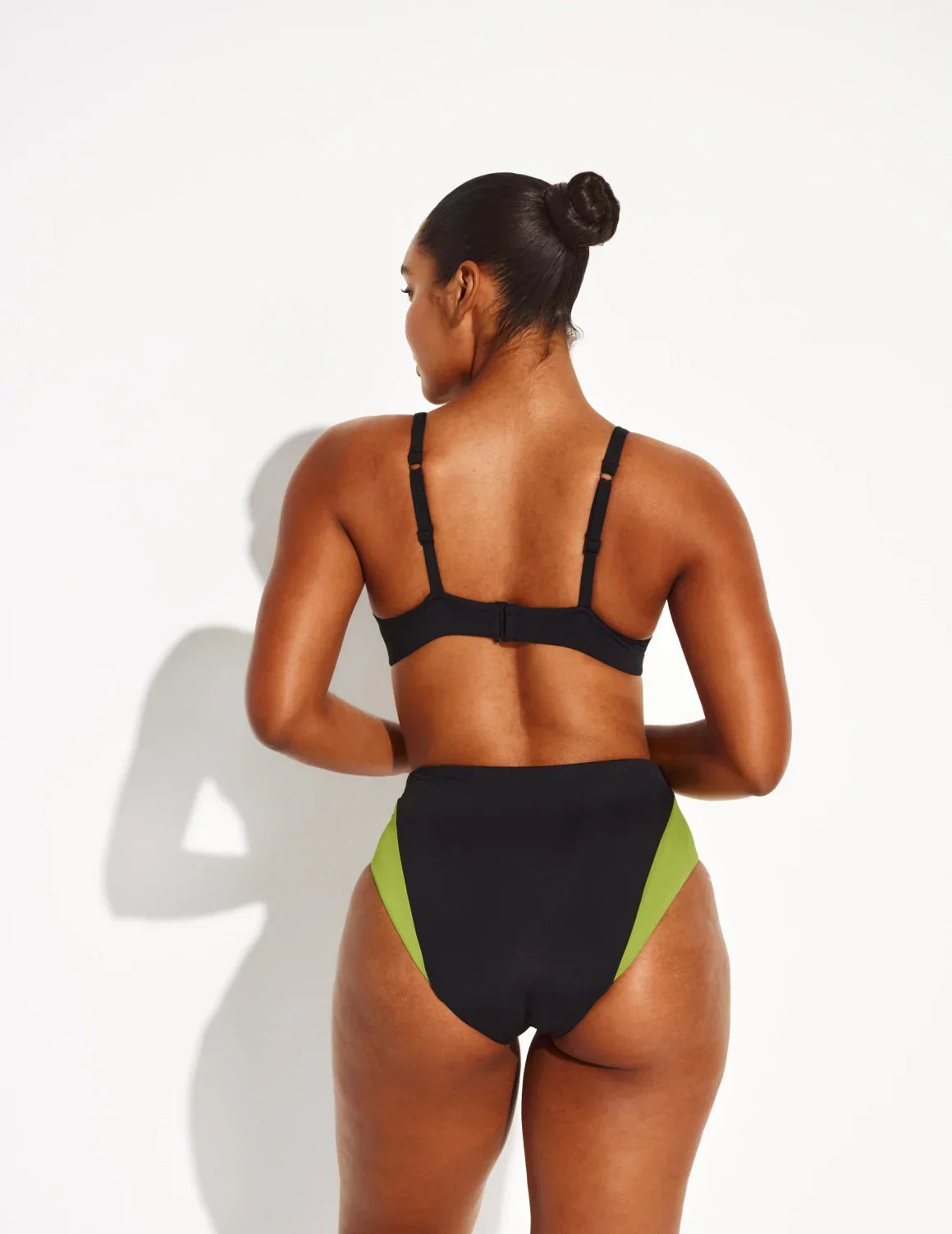 Back view of model wearing the Ruched Deep V Bikini Top, highlighting the neckline, strap design, and silhouette – Black – view 8 of 18