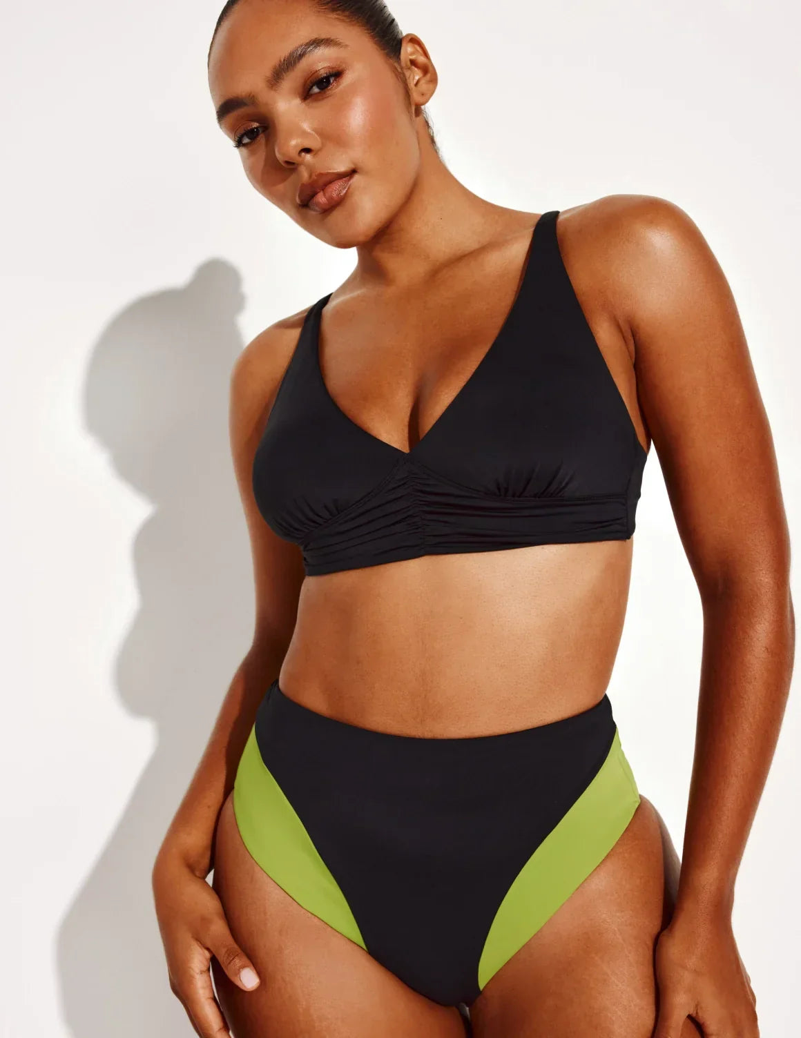 Full-body view of model wearing the Ruched Deep V Bikini Top, highlighting the neckline, strap design, and silhouette – Black – view 10 of 18
