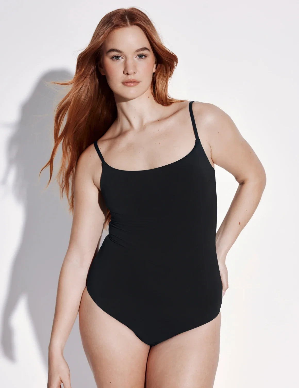Front view of model wearing the Sculpt Classic One Piece Swimsuit highlighting the neckline, coverage and fit – Black – view 1 of 3