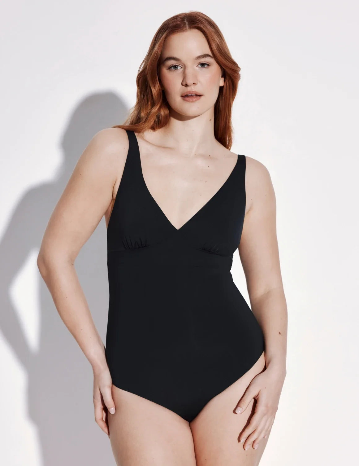 Front view of model wearing the Sculpt Deep V One Piece Swimsuit highlighting the neckline, coverage and fit – Black – view 1 of 3