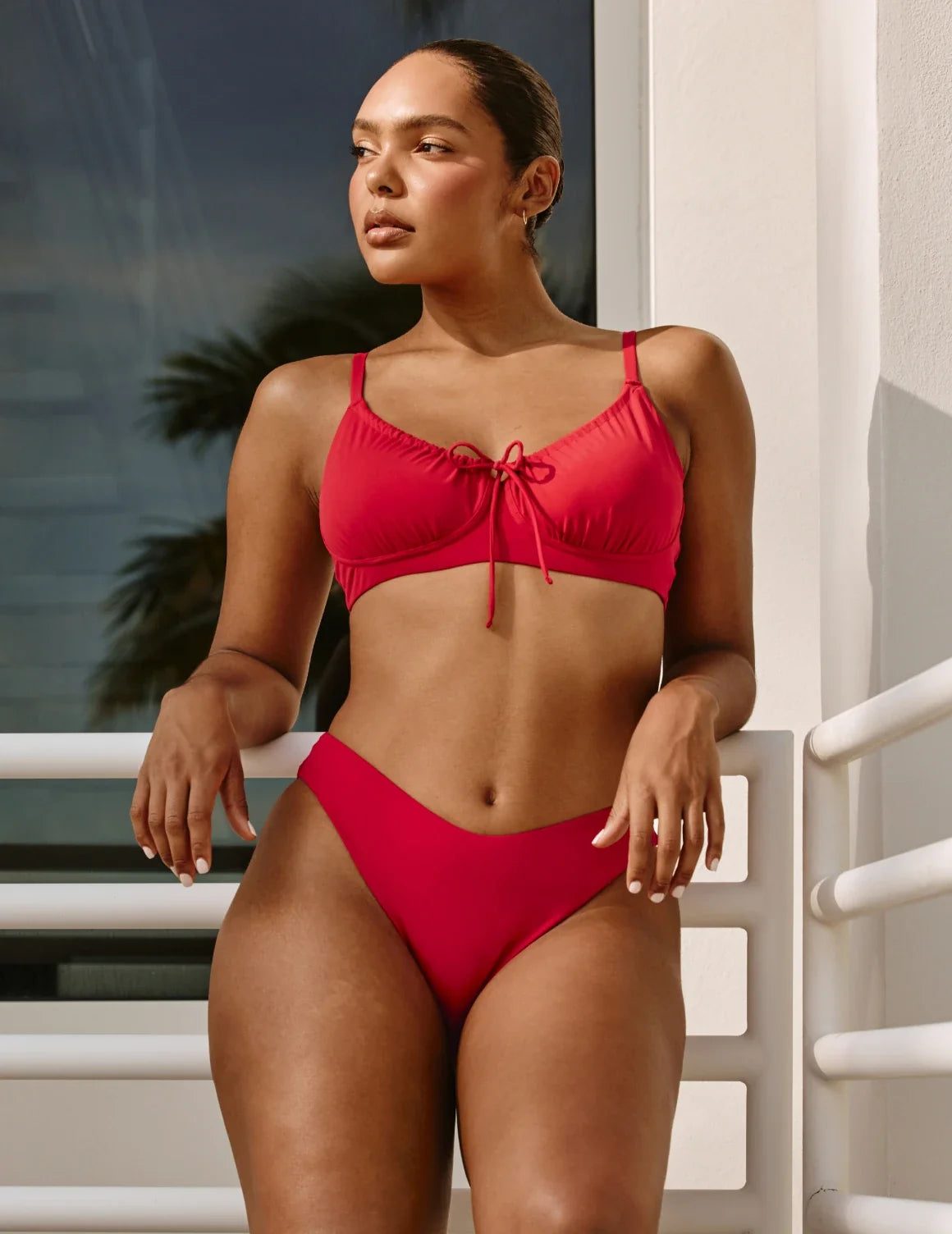 Front view of model wearing the Sculpt Dipped Bikini Swim Bottom highlighting the coverage and fit – Cherry – view 5 of 8