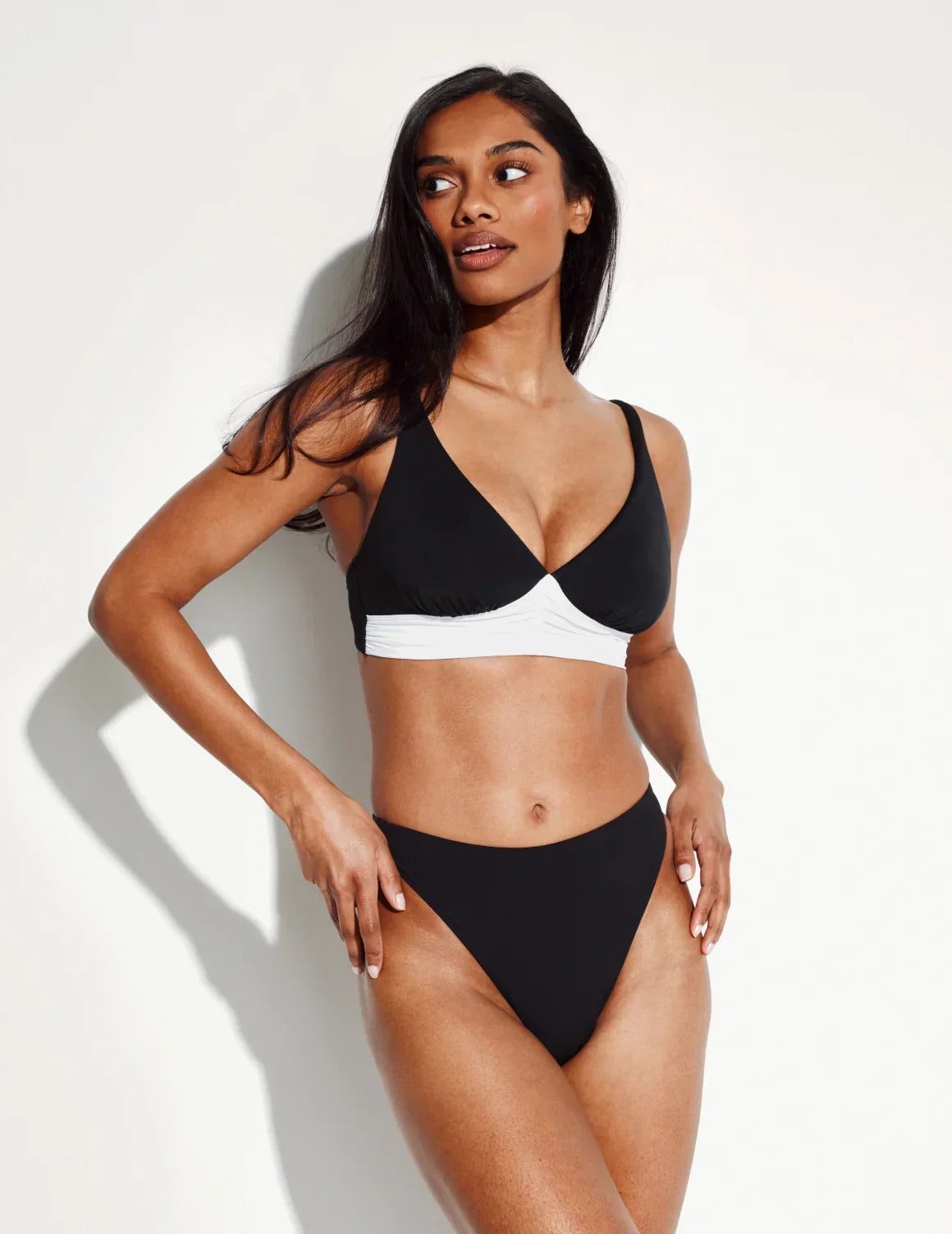 Front view of model wearing the Sculpt High Cut Bikini Swim Bottom highlighting the coverage and fit – Black – view 1 of 40