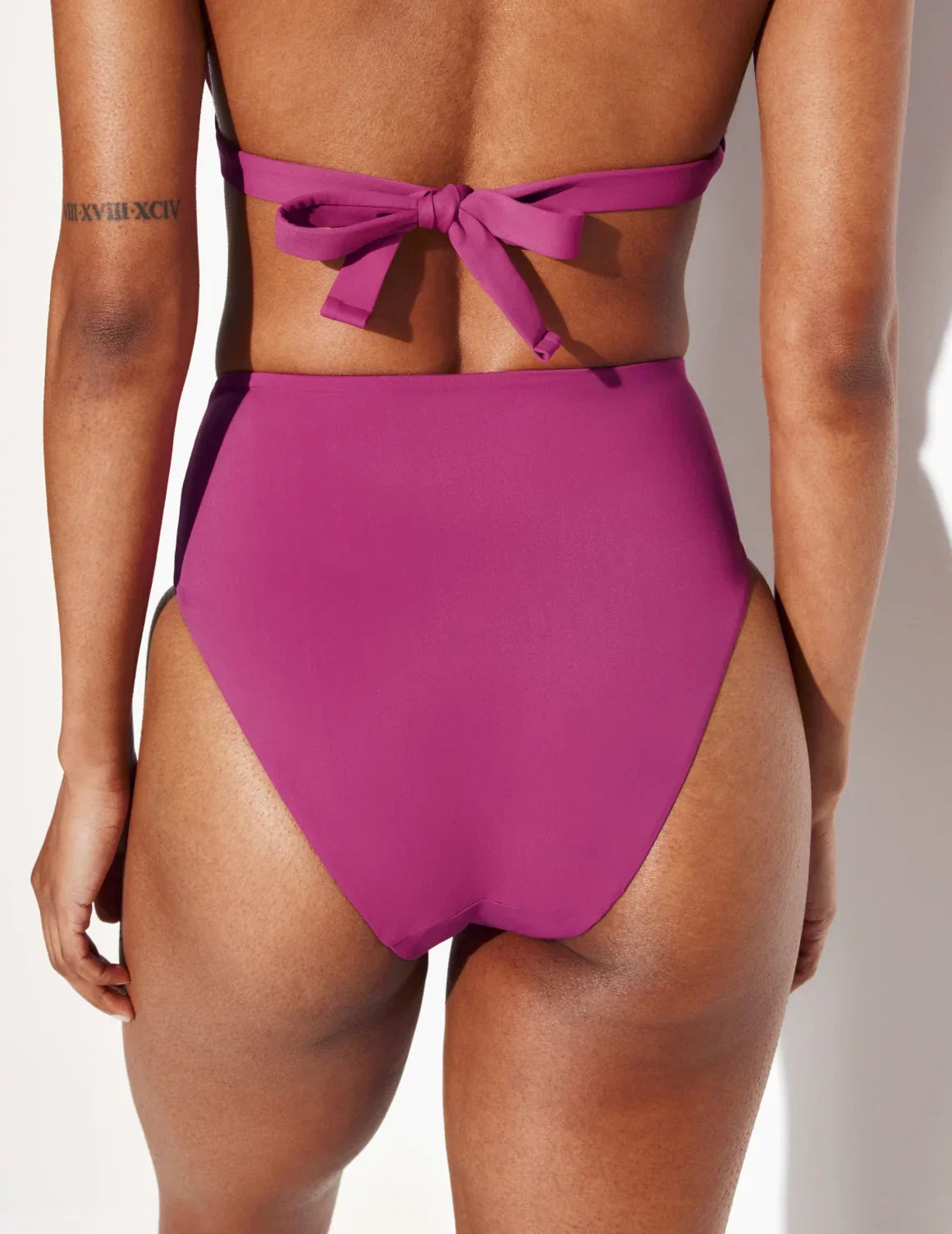 Back view of model wearing the Sculpt High Rise Bikini Swim Bottom highlighting the coverage and fit – Deep Orchid – view 11 of 36