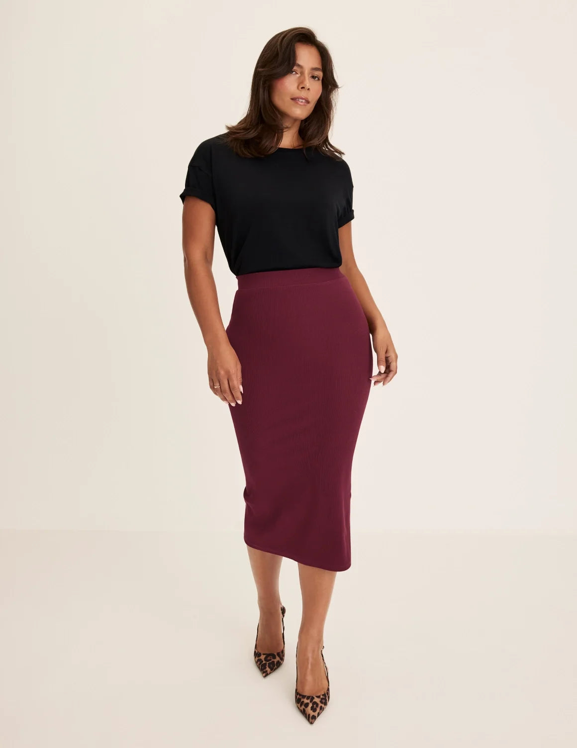 Front view of model wearing the SculptRib™ Cotton Midi Pencil Skirt highlighting the hemline, fabric and hugging fit – Dark Cherry – view 6 of 23