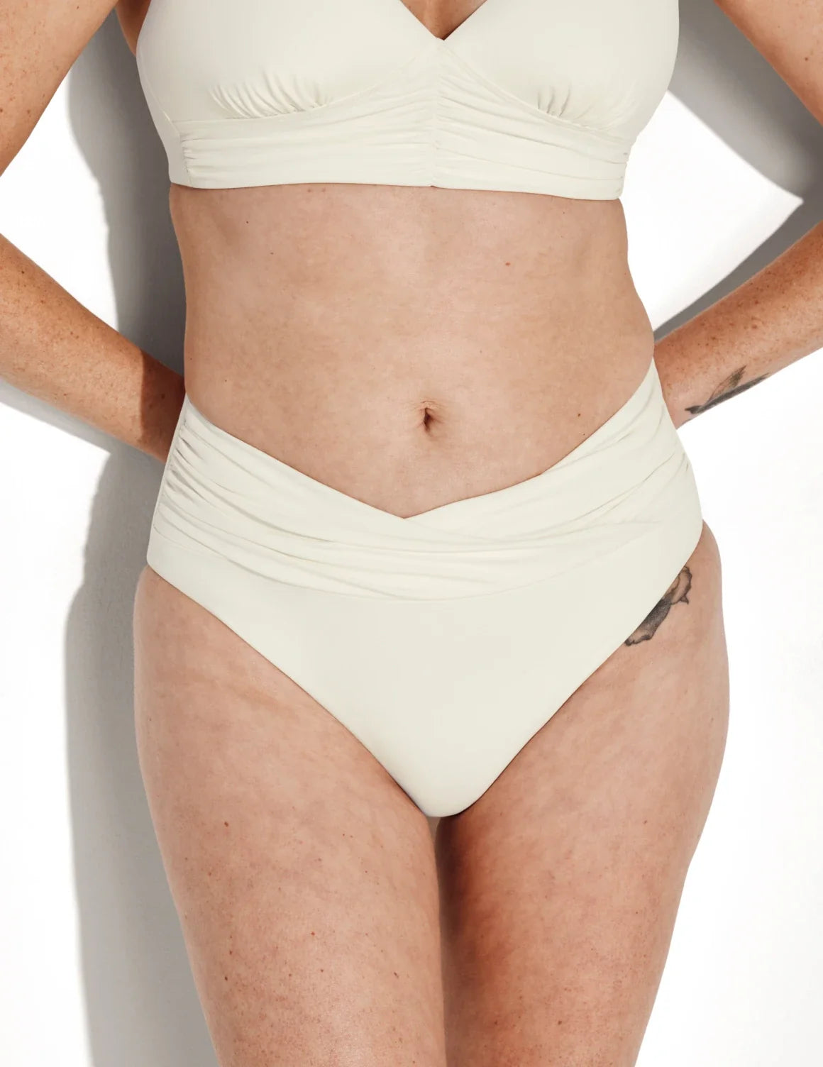 Front view of model wearing the Sculpt Ruched Bikini Swim Bottom highlighting the coverage and fit – Ivory – view 3 of 14