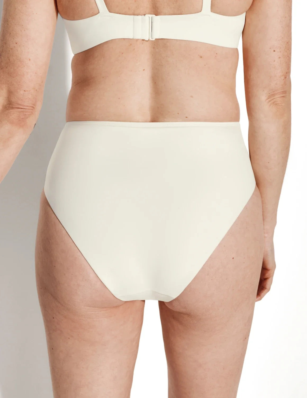Back view of model wearing the Sculpt Ruched Bikini Swim Bottom highlighting the coverage and fit – Ivory – view 4 of 14