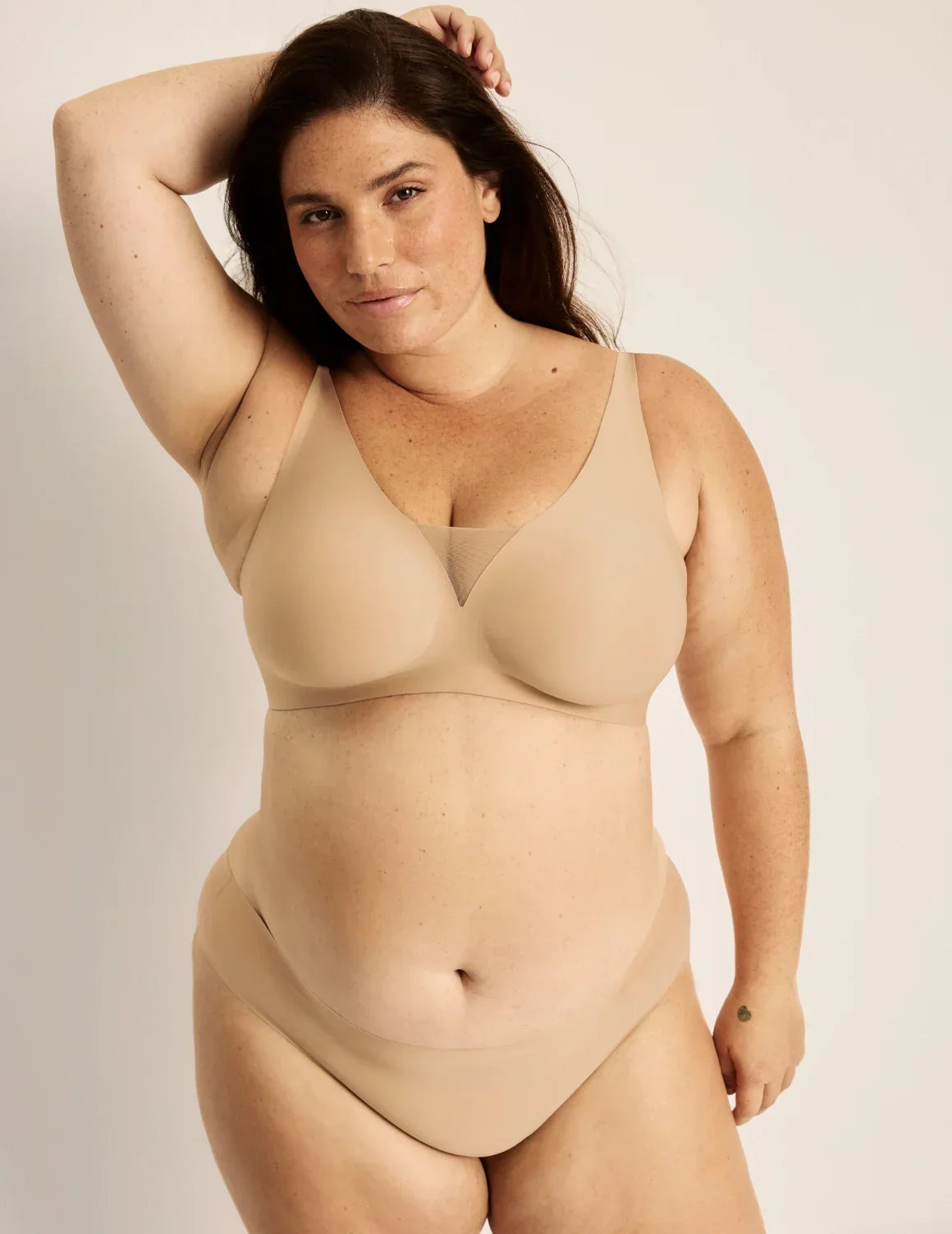 Full-body view of model wearing the Revolution Shadow Mesh Bra, highlighting the neckline, strap design, and silhouette – Warm Sand – view 5 of 19