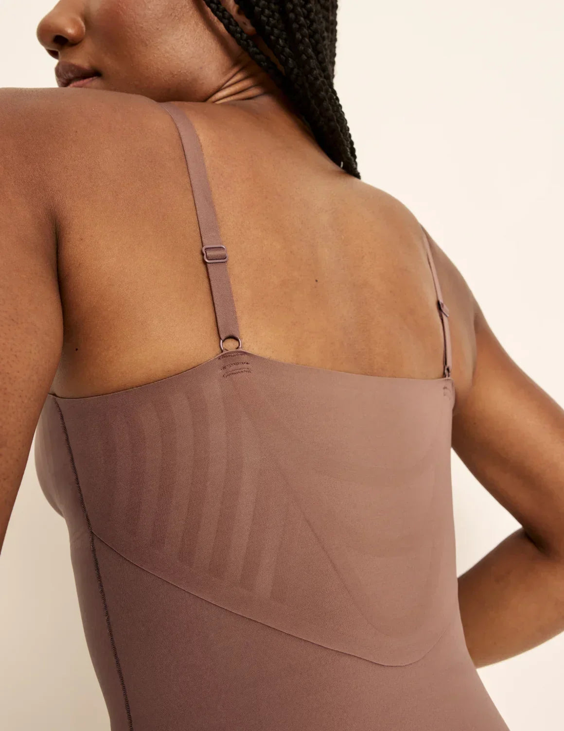 Back view of model wearing the Customizable Shaper Thong Bodysuit highlighting the coverage and smooth fit – Sola – view 11 of 15