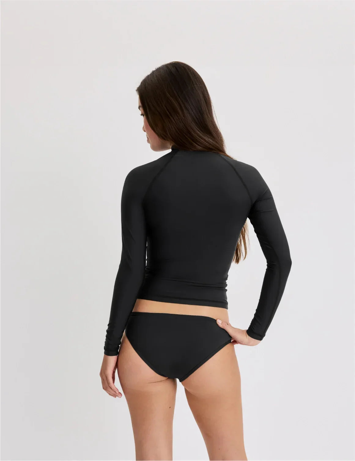 Back view of model wearing the Teen Sunny Skies Rash Guard highlighting the coverage and fit – Black – view 5 of 10