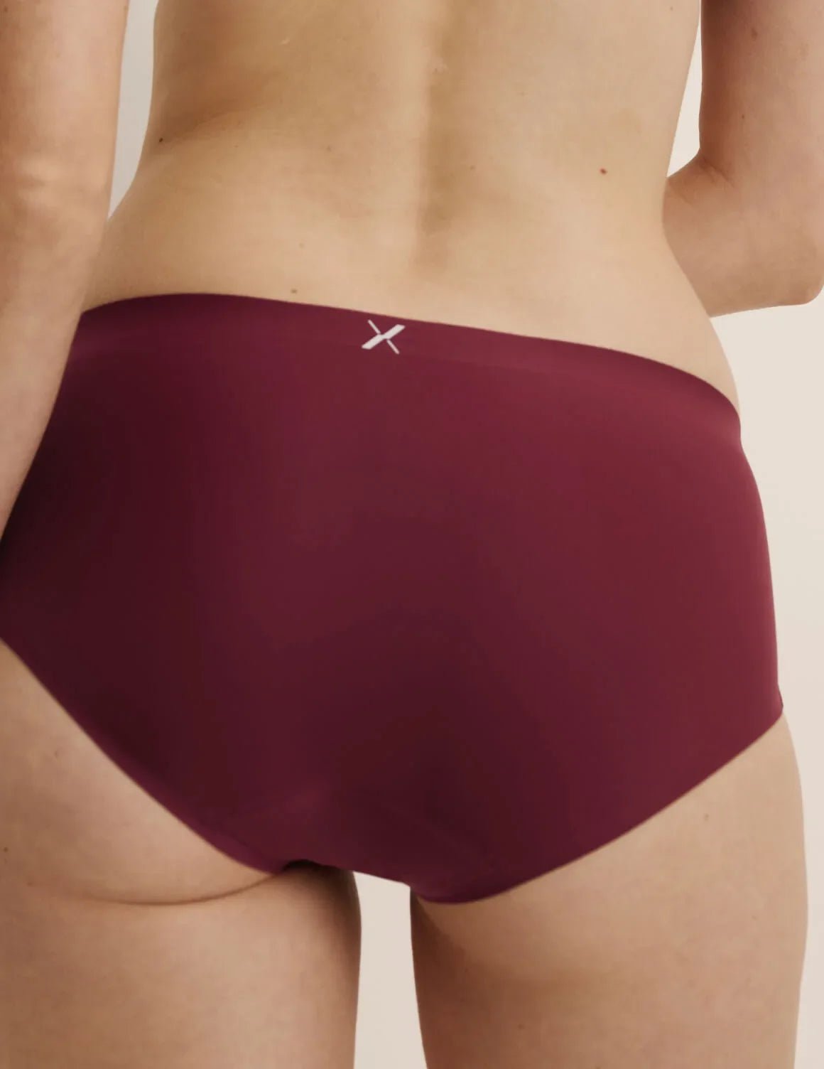 Back view of model wearing the Super Leakproof® No-Show Boyshort highlighting the coverage and smooth fit – Dark Cherry – view 12 of 28