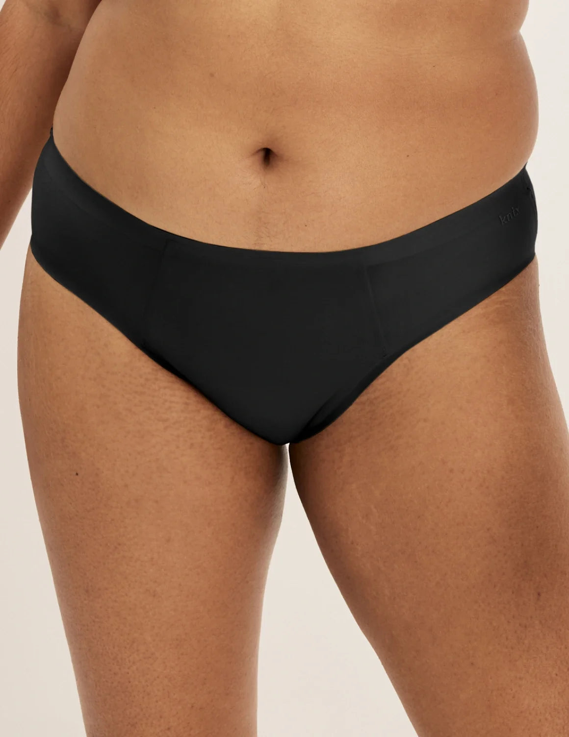 Front view of model wearing the SuperPlus Leakproof® No-Show Bikini highlighting the coverage and smooth fit – Black – view 1 of 21