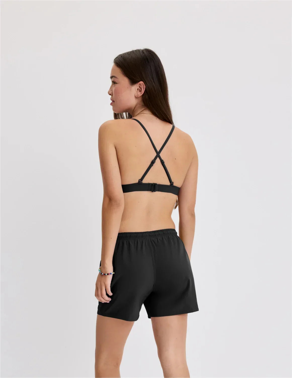 Back view of model wearing the Teen Triangle Bikini Top highlighting the neckline, strap design and fit – Black – view 11 of 48