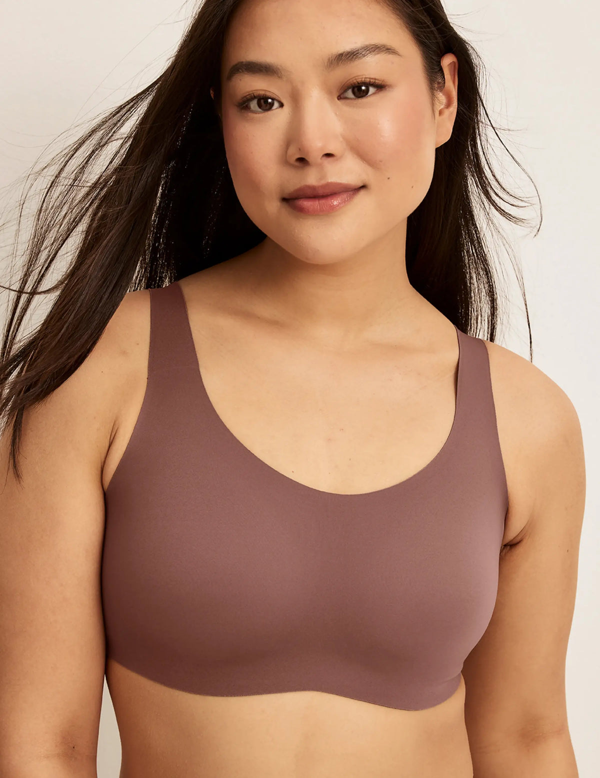 Front view of model wearing the Revolution Adjustable Pullover Bra, highlighting the neckline, strap design, and silhouette – Sola – view 3 of 20